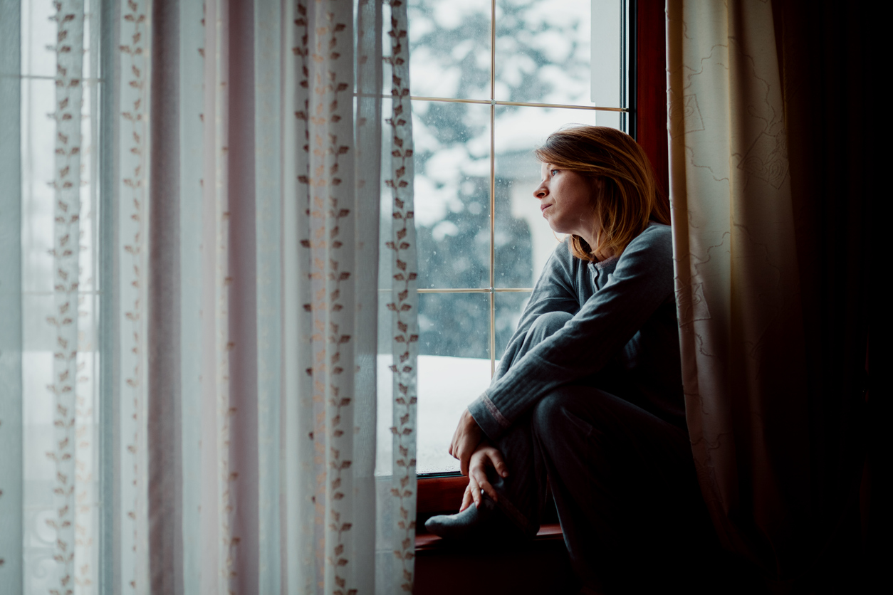 Woman looking out window