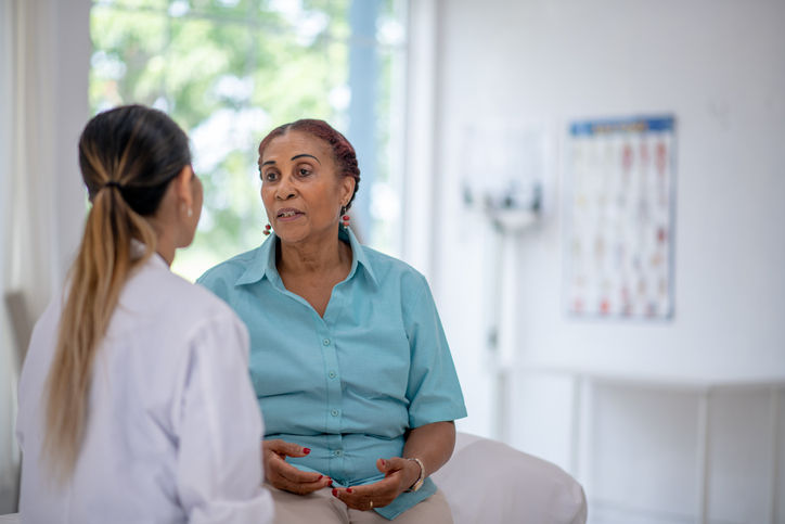 Senior woman speaking with doctor