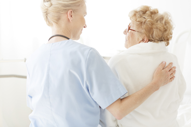Nurse comforting an elderly woman