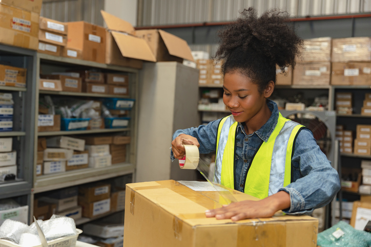 Woman taping up a box for shipping