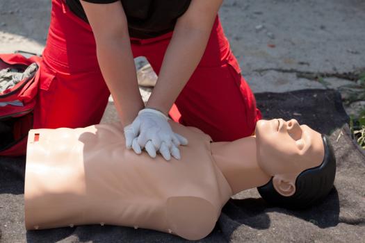 EMT practicing CPR on dummy